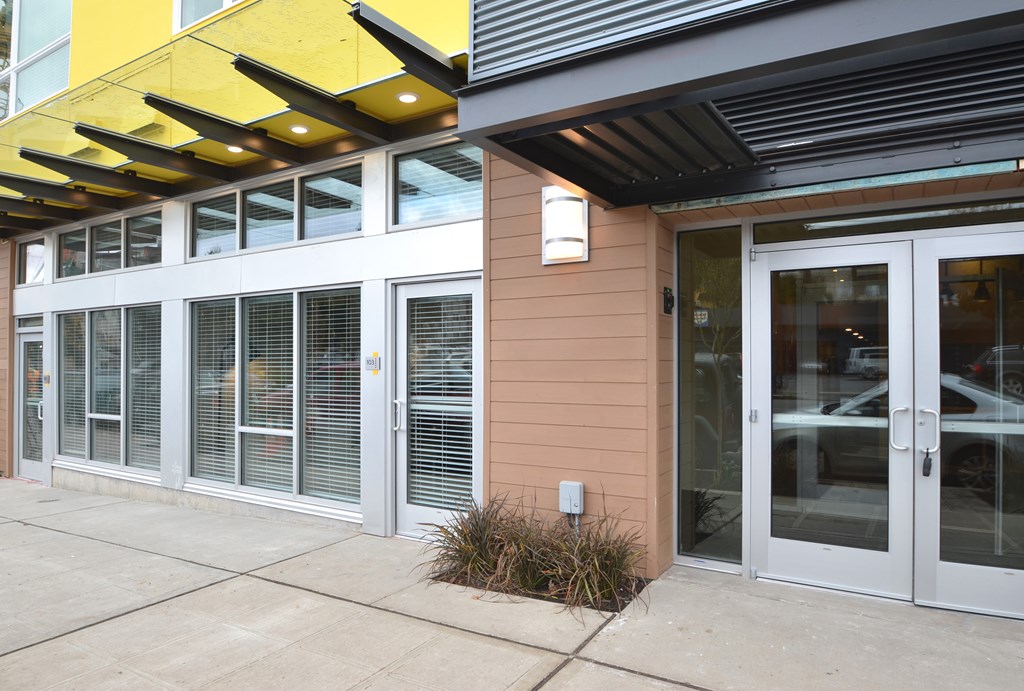A building with a yellow awning and a brown wall.