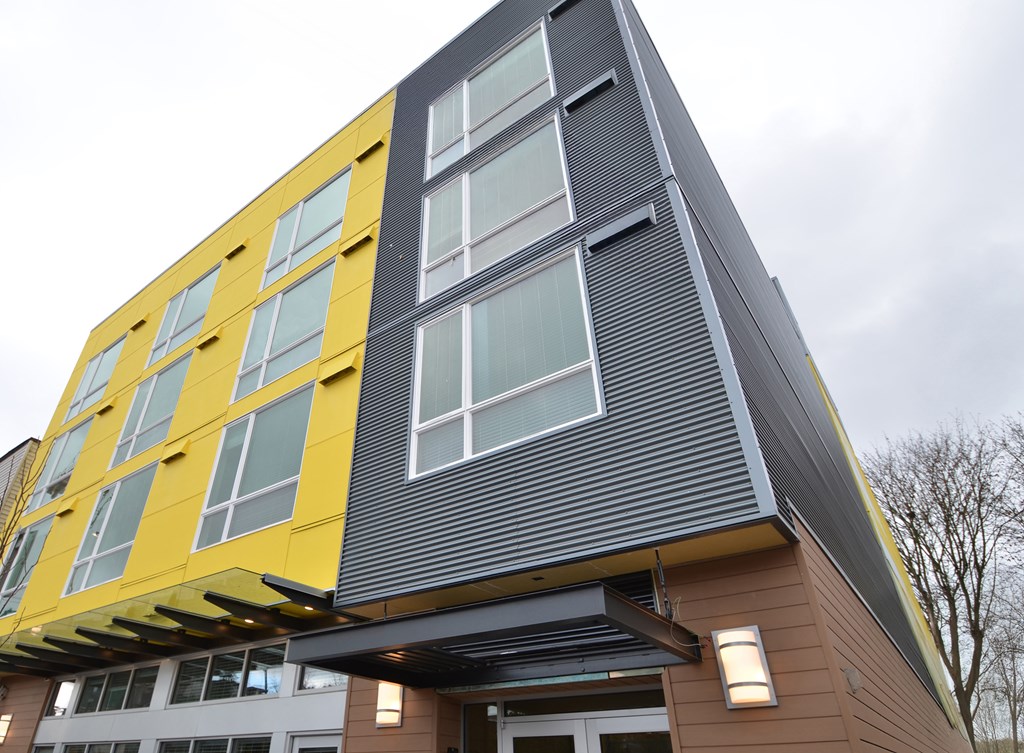 A modern building with a yellow and grey facade.