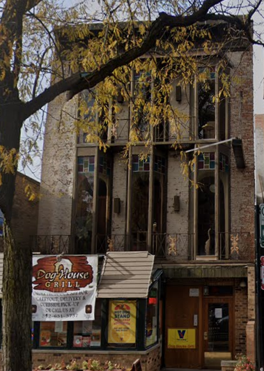 an old building with a sign in front of it