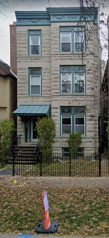 an old house with a cone in front of it