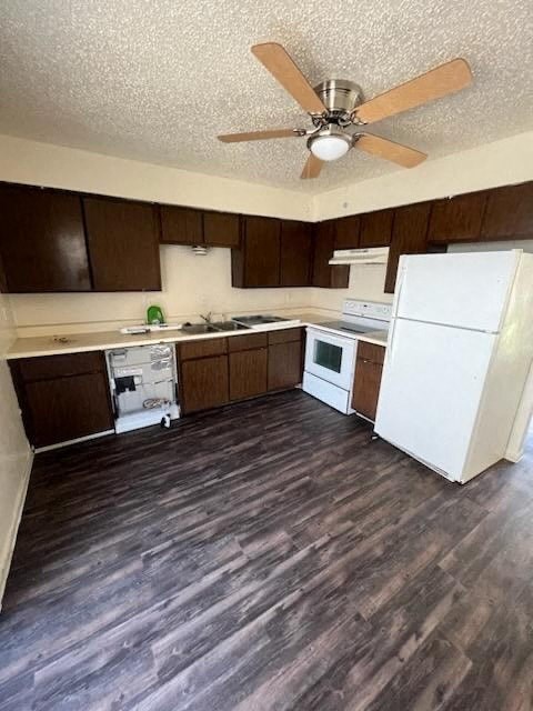 a kitchen with a white refrigerator and a ceiling fan