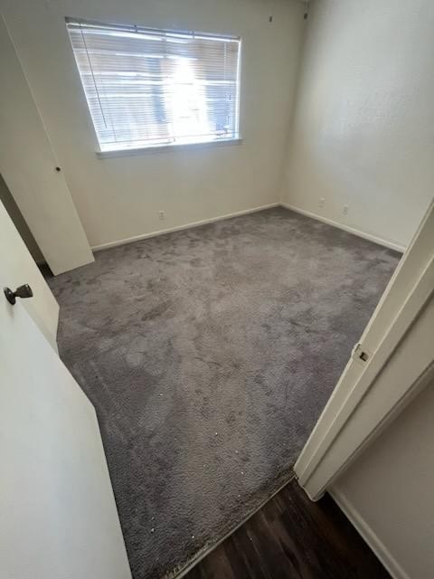 a room with a carpeted floor and a window