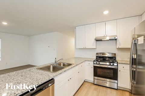 a kitchen with granite counter tops and stainless steel appliances