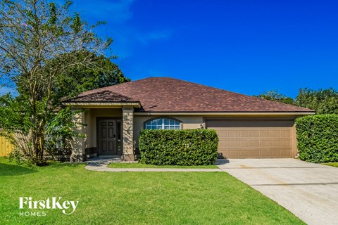 A house with a brown roof and a garage door is shown.