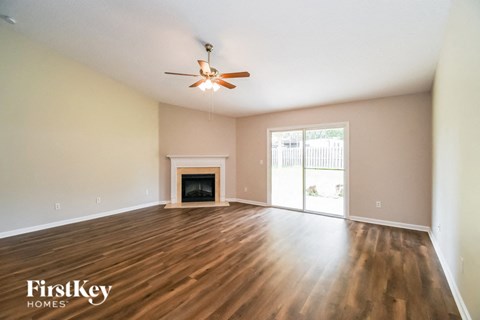 A room with a fireplace and a ceiling fan.