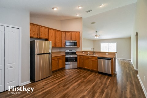 A kitchen with wooden cabinets and stainless steel appliances.