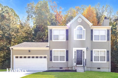 a gray house with a white garage door