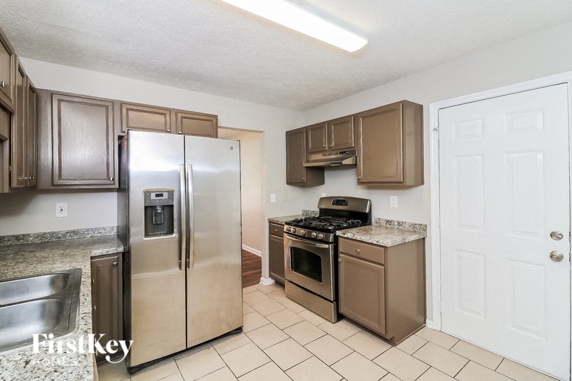 a kitchen with stainless steel appliances and granite counter tops