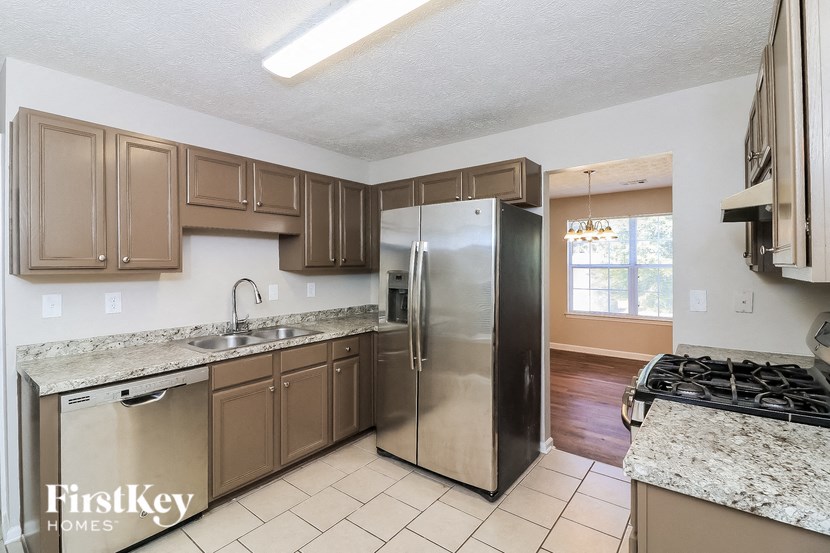 a kitchen with stainless steel appliances and granite counter tops