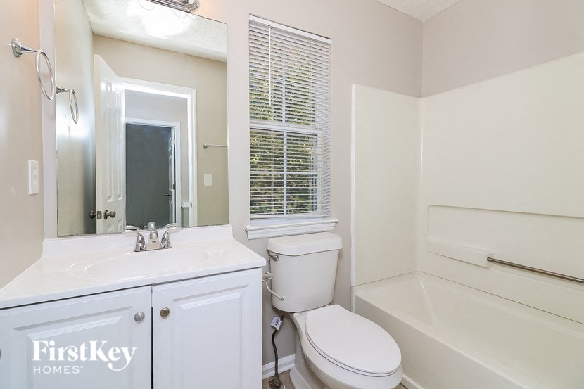 a bathroom with a sink toilet and a bath tub