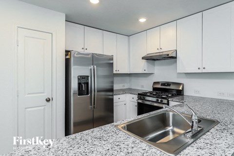 a kitchen with a sink and a refrigerator