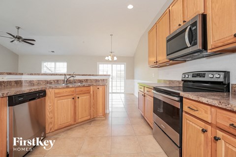 a kitchen with wooden cabinets and stainless steel appliances