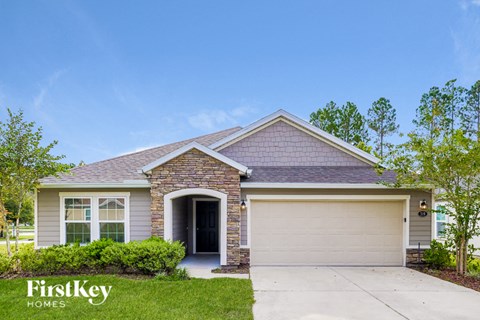 a small brick house with a garage door