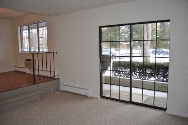 an empty living room with a large window and