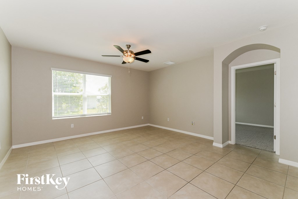 A spacious room with a fan and a window.