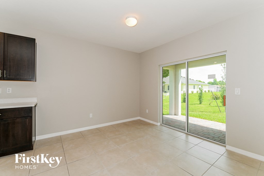 A room with a sliding glass door leading to a backyard.