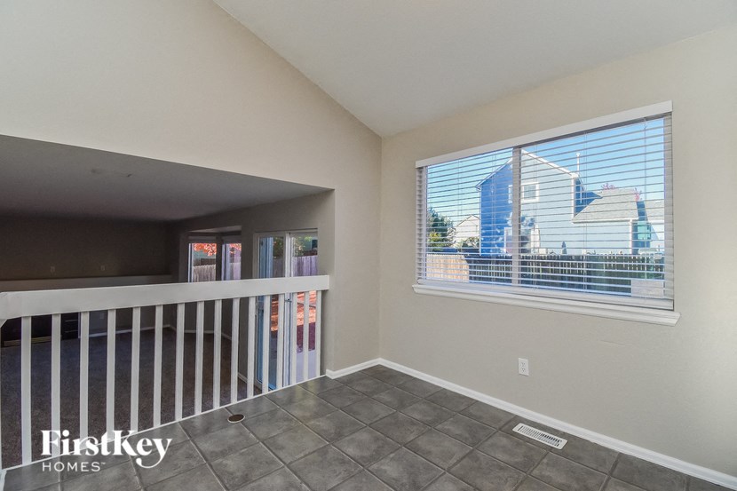 a balcony with a large window and a white railing