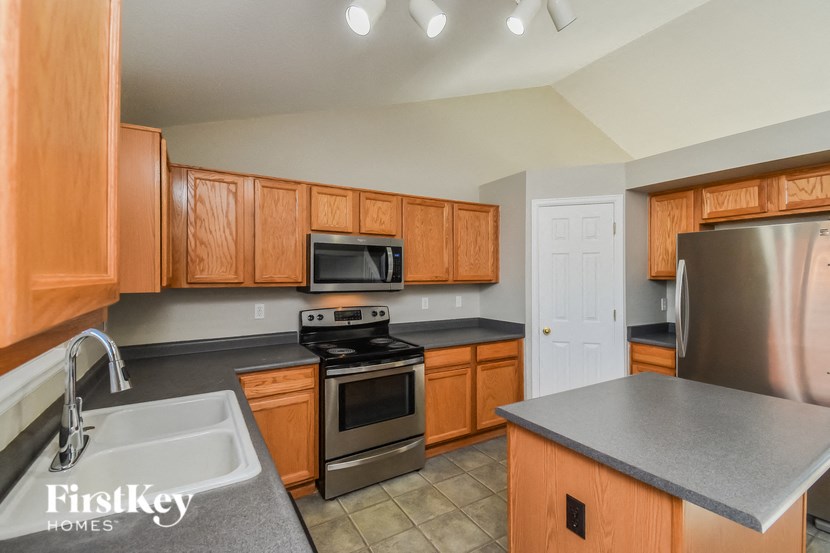 a kitchen with wooden cabinets and stainless steel appliances