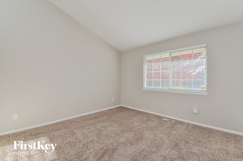 the second bedroom with carpet and a window