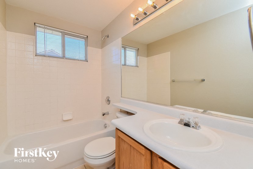 a bathroom with a sink and a toilet and a bath tub