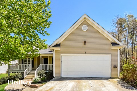 a yellow house with a white garage door