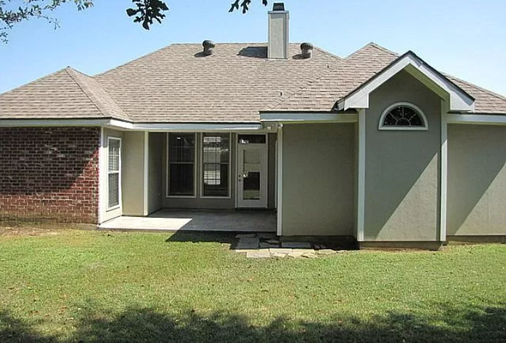 a small house with a yard and a door