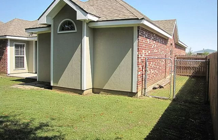 a house with a yard and a fence