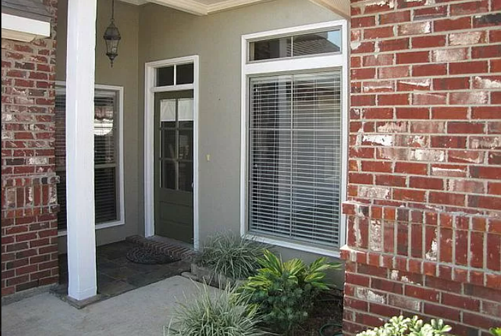 a brick house with two windows and a door