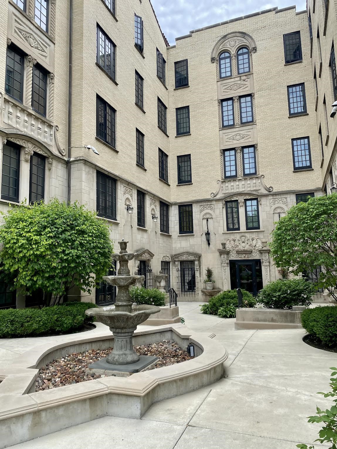 a fountain in a courtyard in front of a building