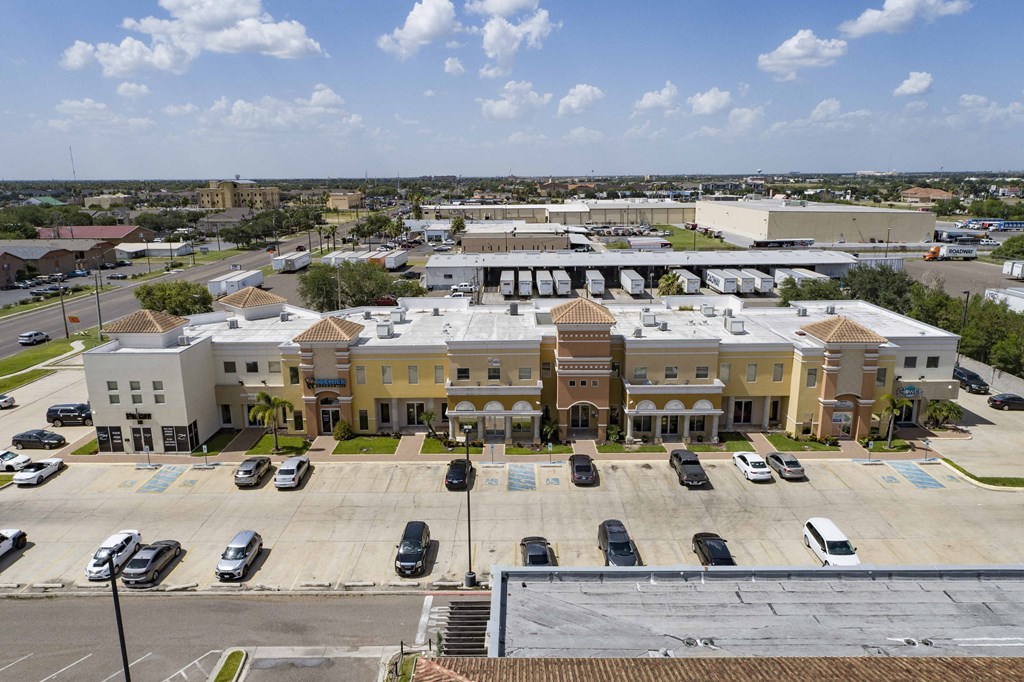 an aerial view of a city with buildings and parking lot