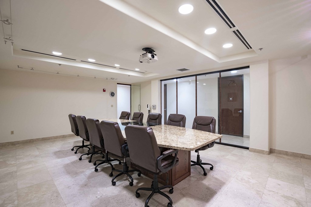 a conference room with a long table and chairs