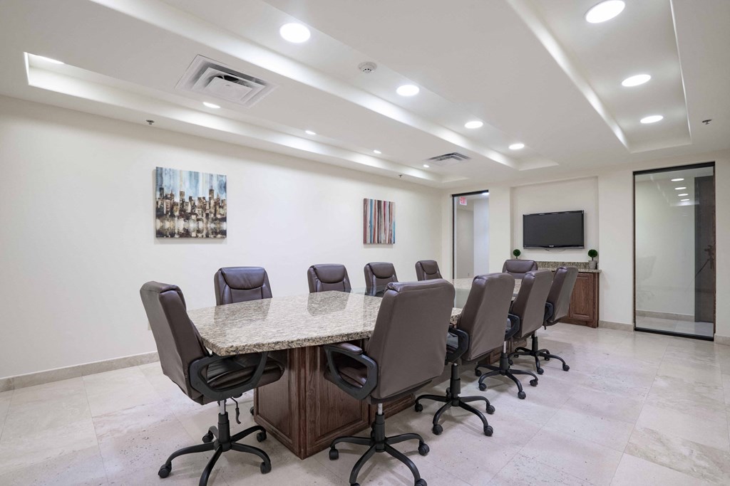 a conference room with a long table and chairs
