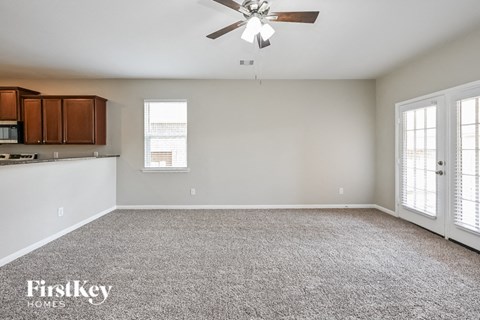 A spacious room with a ceiling fan and a window.