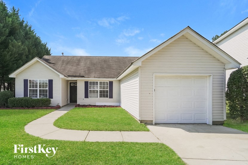 A house with a white garage door and a brown roof.