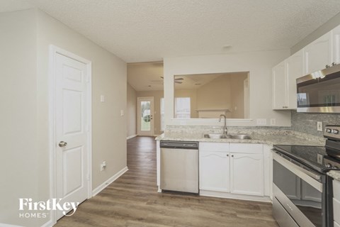 A kitchen with a dishwasher and a stove top oven.