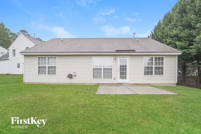 A house with a grey roof and a white garage door.