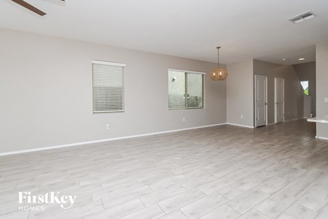 a large empty living room with a wood floor