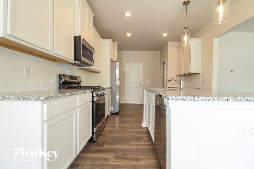a kitchen with white cabinets and a counter top