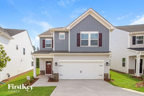 a white and gray house with a white garage door