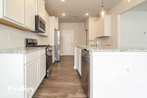 a kitchen with white cabinets and a counter top