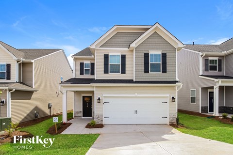 a beige house with a white garage door