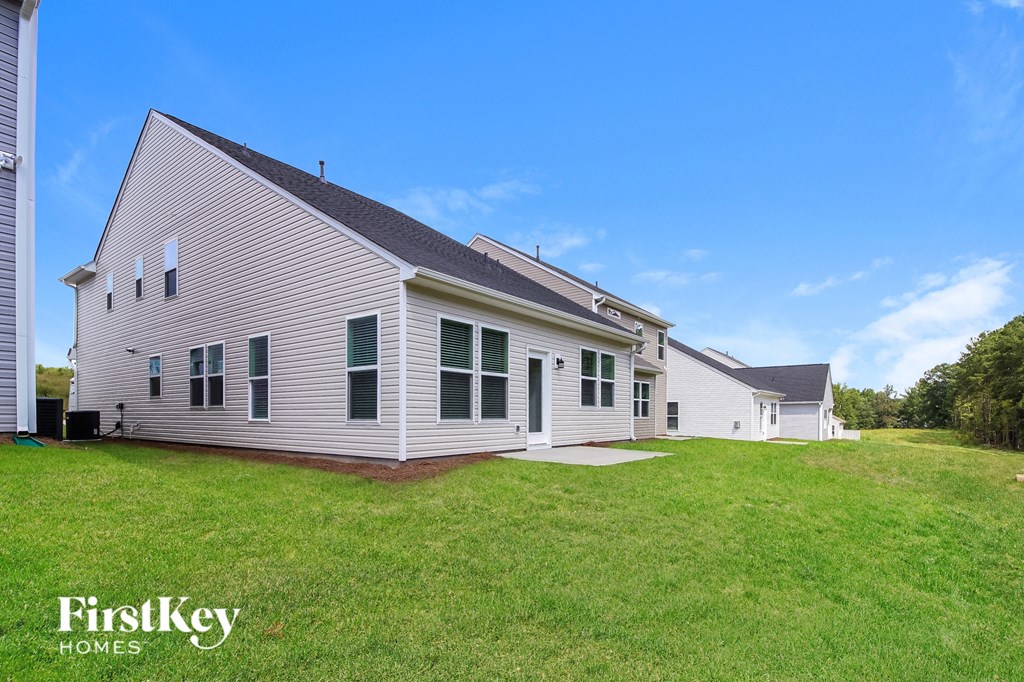 a white house with a yard in front of it