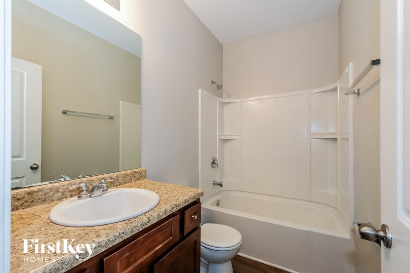 A bathroom with a sink, toilet and bathtub.