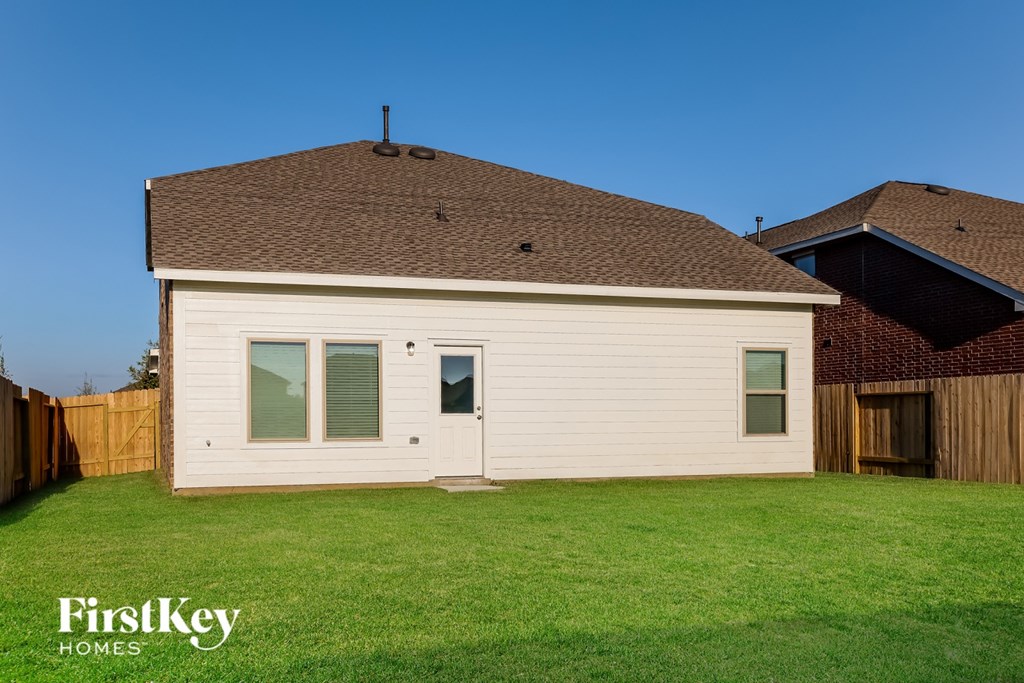 A house with a brown roof and a white garage door.
