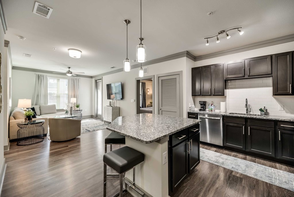 a kitchen and living room with a granite counter top