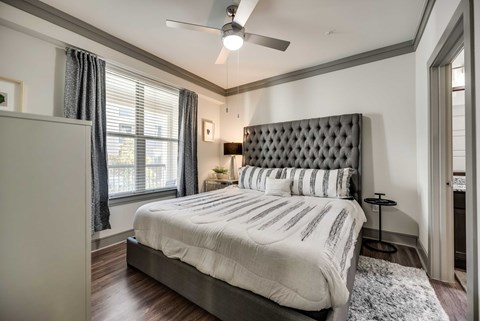 a bedroom with a bed and a ceiling fan
