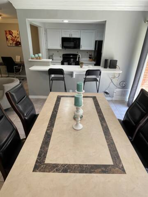 a dining room table with a kitchen in the background