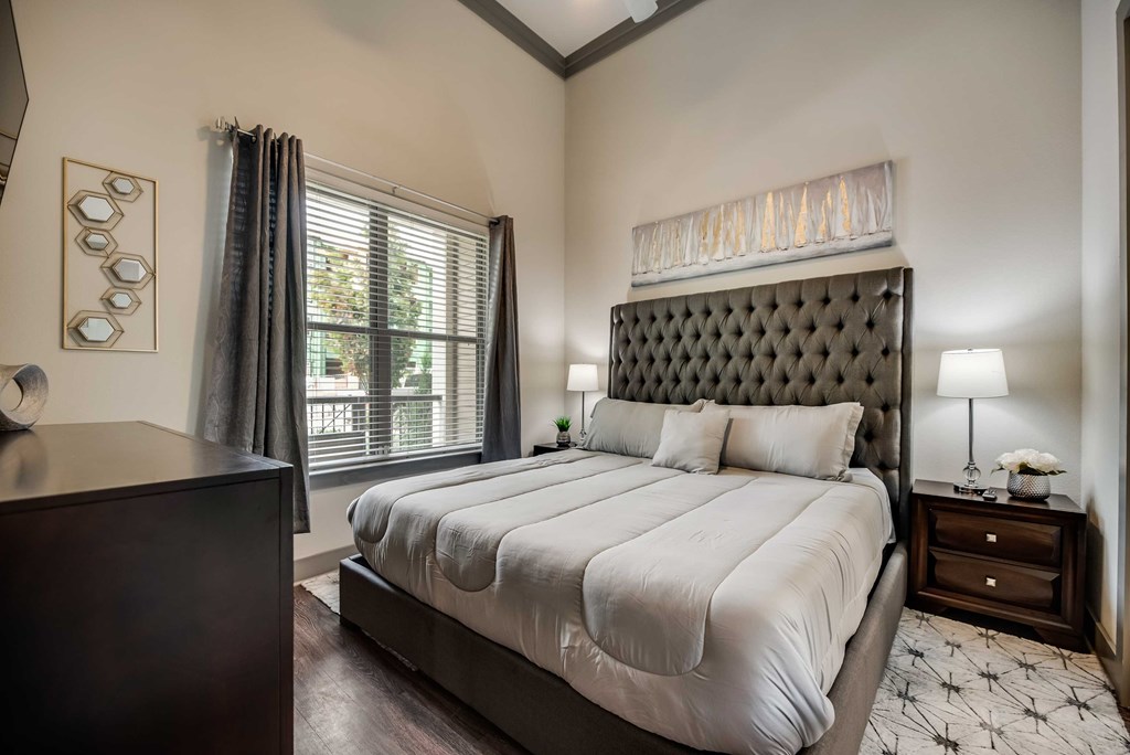 a bedroom with a large bed and a window