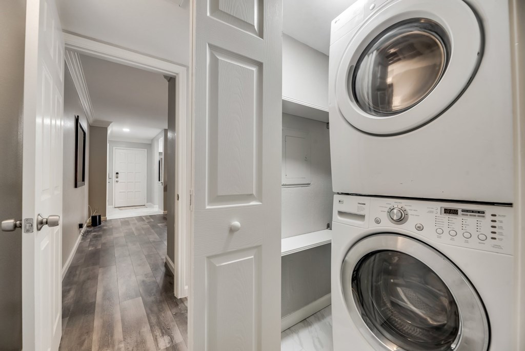 a white washer and dryer in a laundry room with a white door