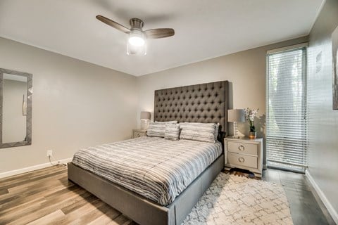 a bedroom with a bed and a ceiling fan